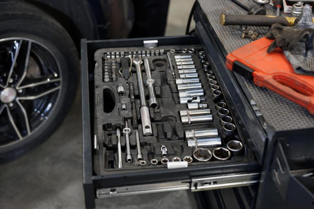 A well-organized Husky tool box set in a sunlit garage, showcasing essential tools.